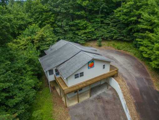 An aerial view of Buck's Cottage, located in secluded woods in a beautiful setting