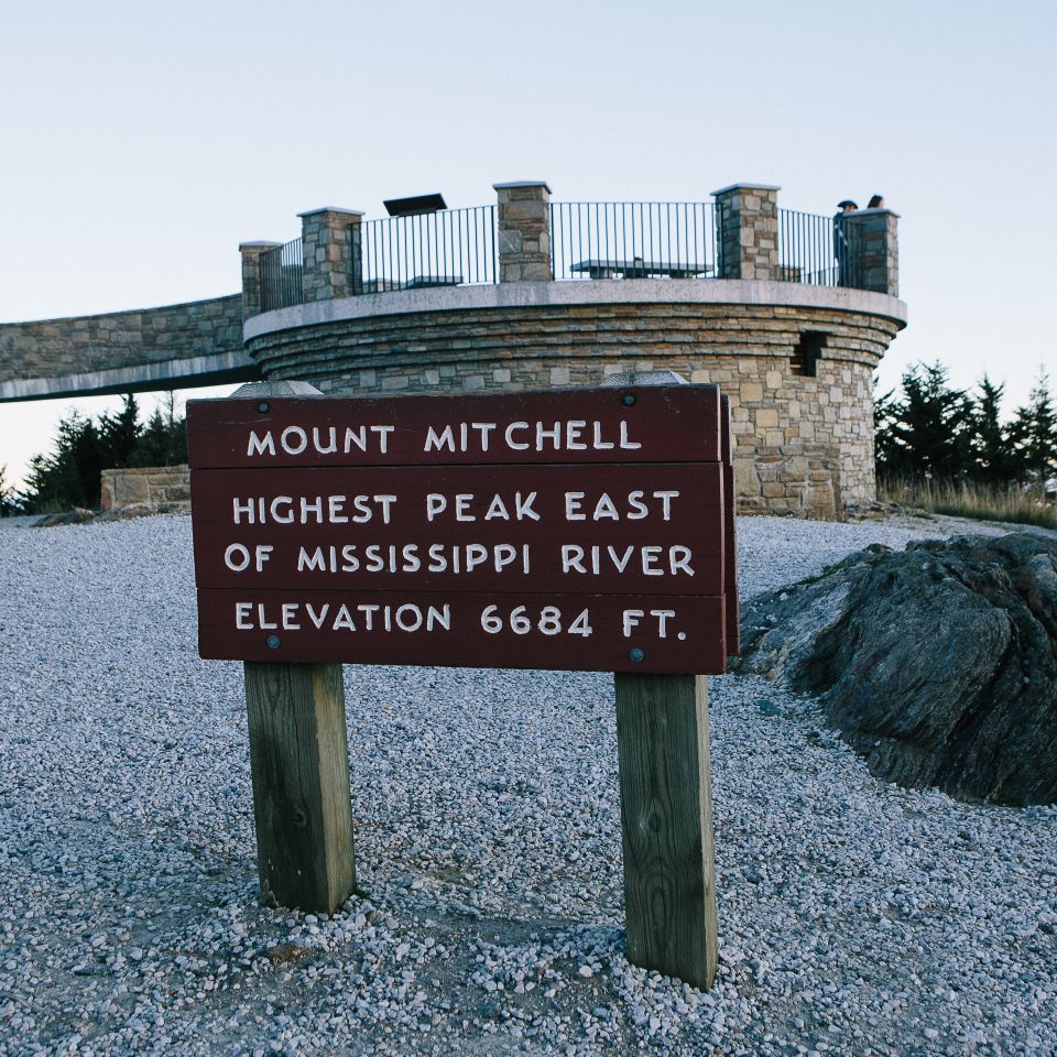 Photo of Mount Mitchell sign with tower in the background